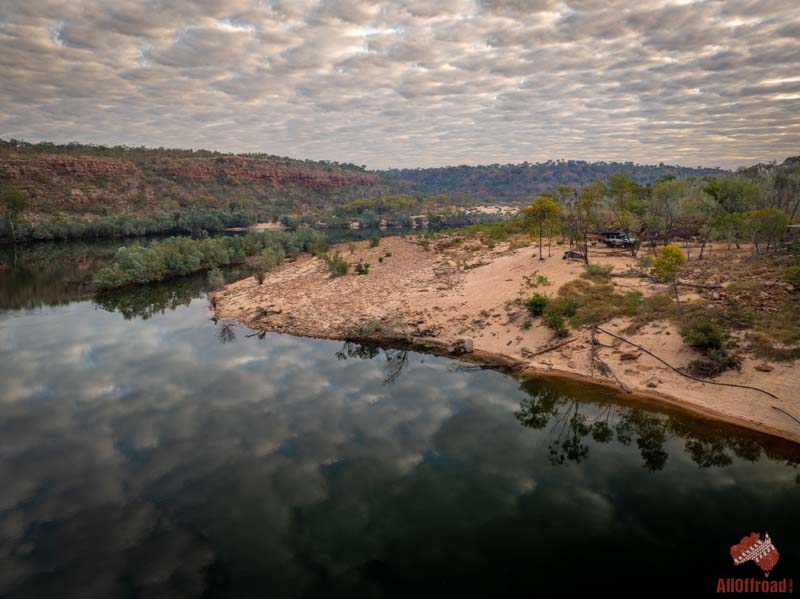 Camera Pool on the Oombulgurri Track, a sandy camp on a river bend below red cliffs